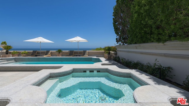 view of swimming pool with an in ground hot tub