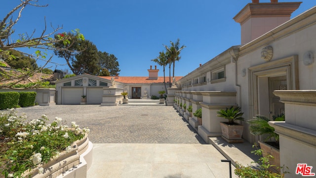 view of front of property featuring a garage and an outdoor structure