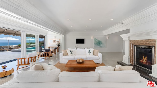 living room featuring crown molding and a water view