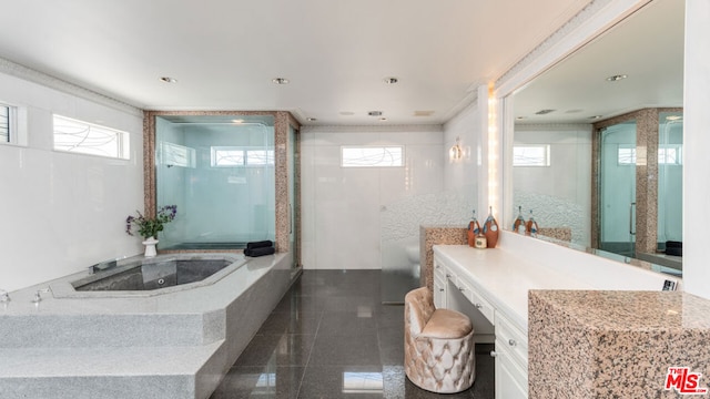 bathroom featuring vanity, ornamental molding, and tiled bath