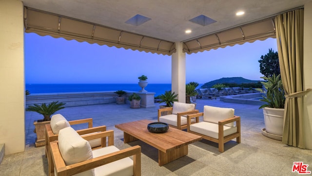 patio terrace at dusk with a water view