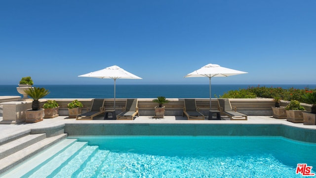 view of pool with a water view