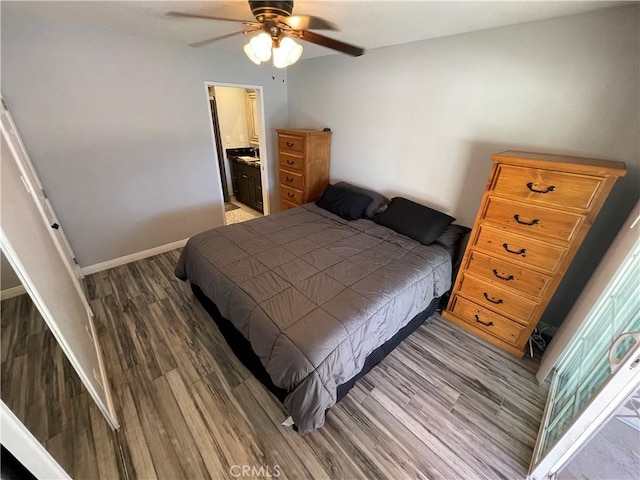 bedroom with ceiling fan, ensuite bathroom, and hardwood / wood-style flooring