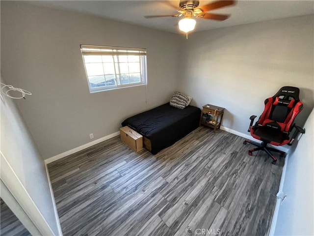 unfurnished bedroom featuring ceiling fan and dark hardwood / wood-style flooring