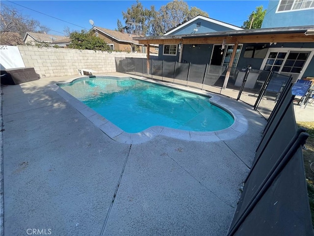 view of swimming pool with a diving board and a patio area