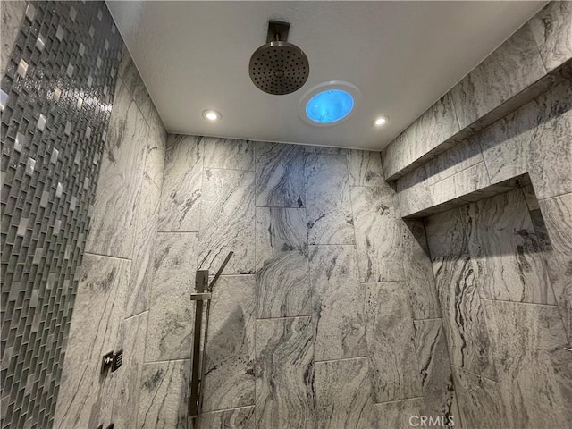 interior details featuring a tile shower