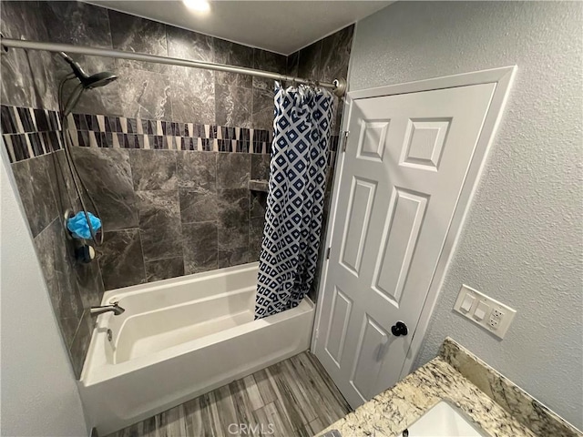 bathroom with wood-type flooring, vanity, and shower / bath combo