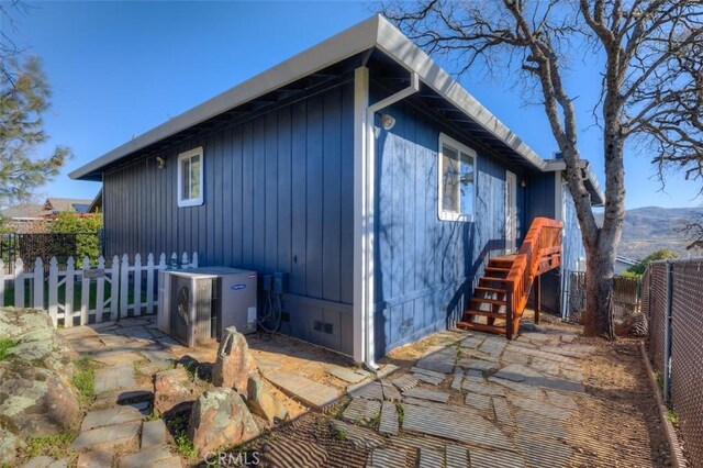 exterior space featuring crawl space, ac unit, and a fenced backyard