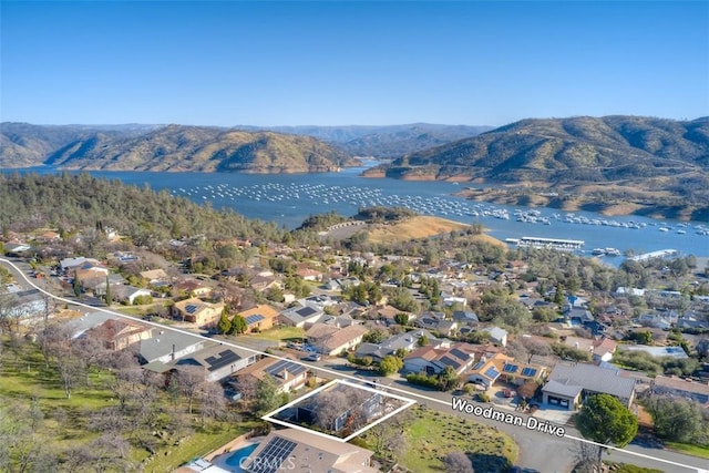 drone / aerial view with a water and mountain view