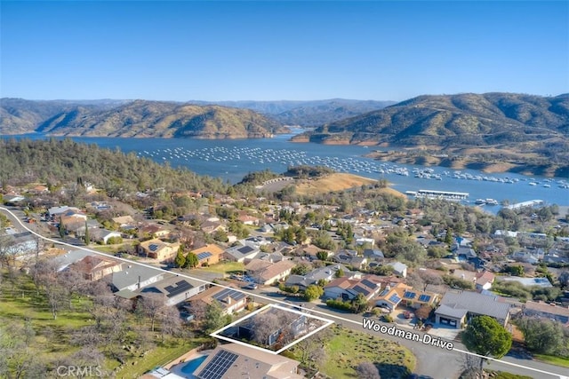 aerial view featuring a water and mountain view and a residential view