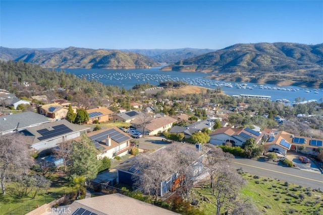 drone / aerial view featuring a water and mountain view