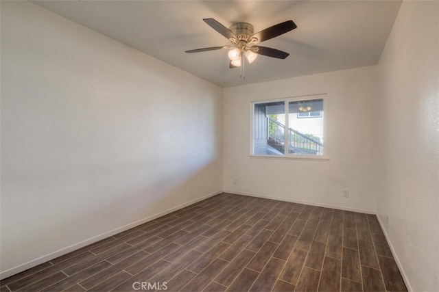 empty room featuring dark wood-style flooring, ceiling fan, and baseboards