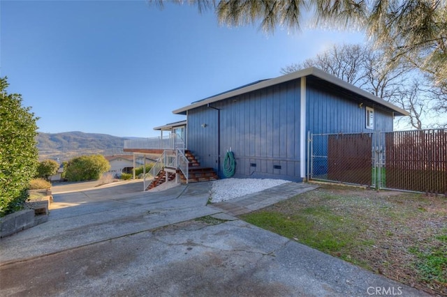 exterior space featuring a mountain view, a gate, and fence