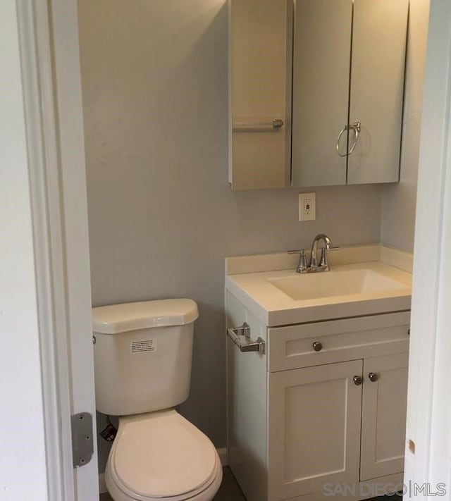 bathroom featuring toilet and vanity