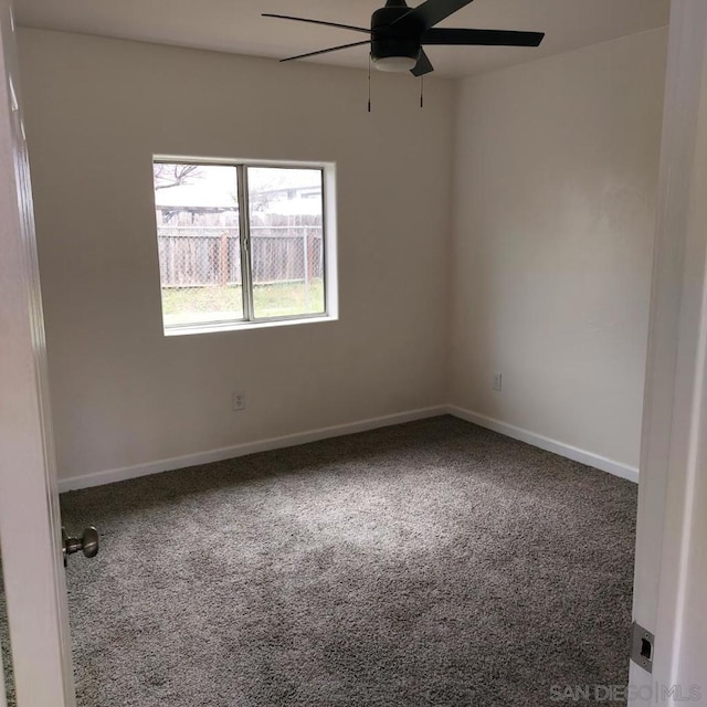 empty room with ceiling fan and carpet flooring