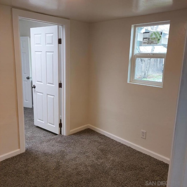 empty room with carpet flooring and plenty of natural light