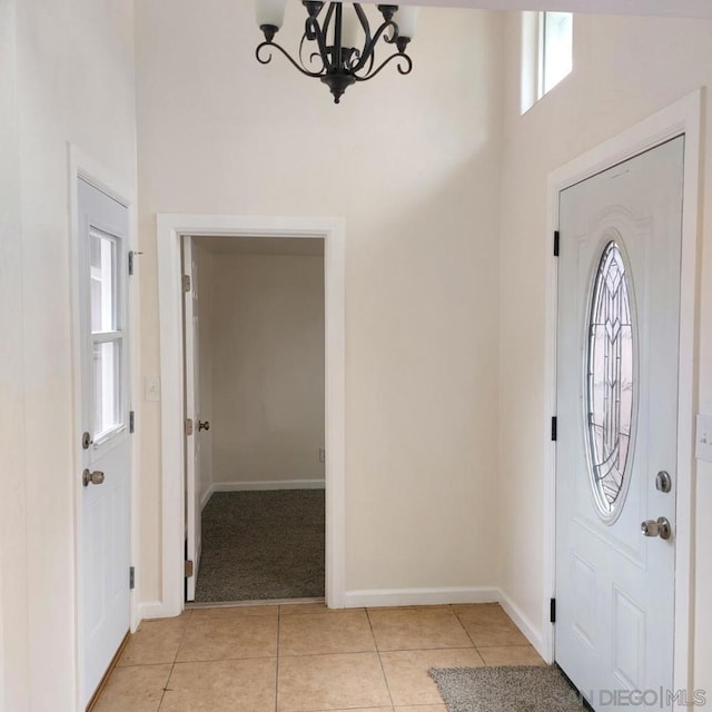 entrance foyer with an inviting chandelier and light tile patterned floors