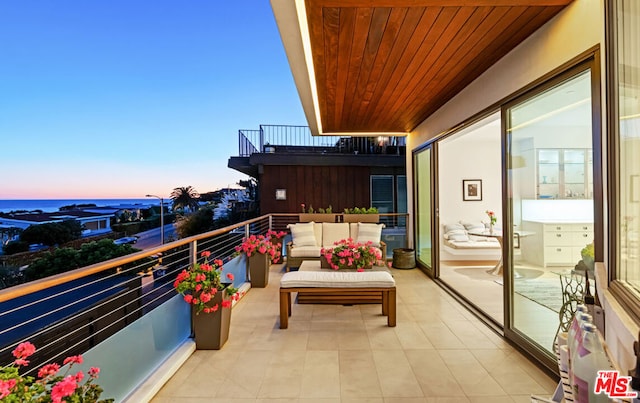 balcony at dusk with an outdoor living space