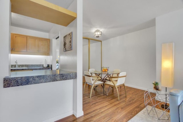 kitchen featuring sink, light brown cabinetry, and light hardwood / wood-style floors