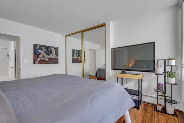 bedroom with hardwood / wood-style flooring and a closet