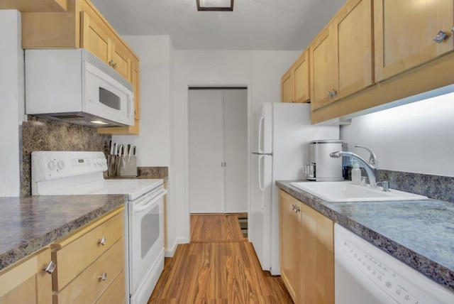 kitchen featuring sink, light hardwood / wood-style flooring, light brown cabinets, white appliances, and decorative backsplash