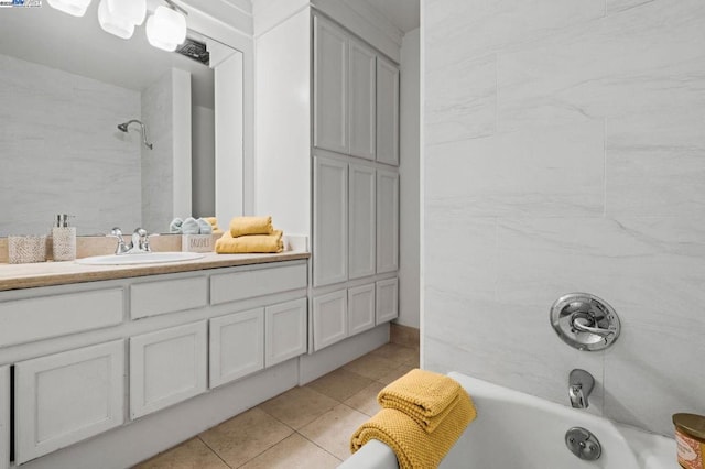 bathroom with vanity, tiled shower / bath, and tile patterned flooring