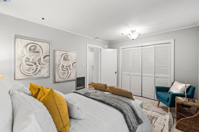 bedroom with crown molding, a closet, and light carpet