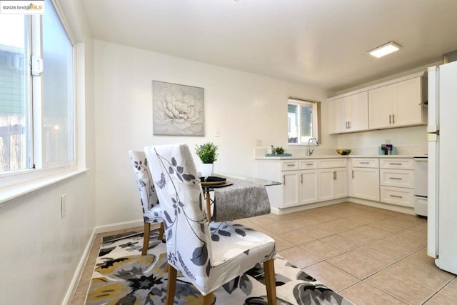 kitchen featuring sink, white cabinets, and light tile patterned floors