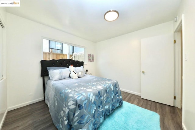 bedroom with dark hardwood / wood-style flooring