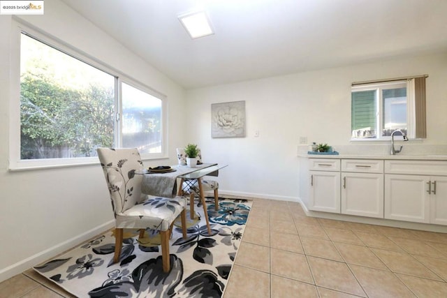 dining space with sink and light tile patterned floors