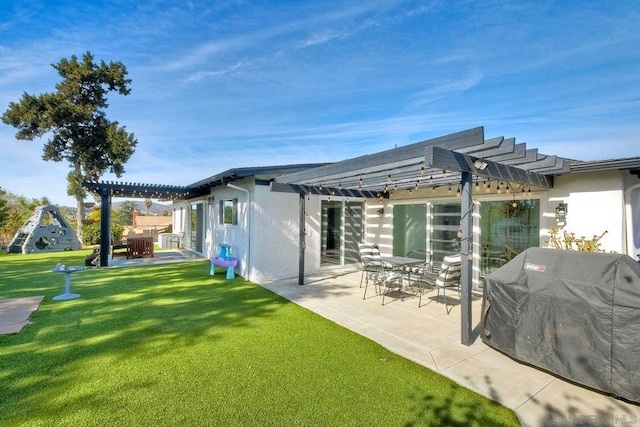 back of house featuring a patio area, a lawn, and a pergola