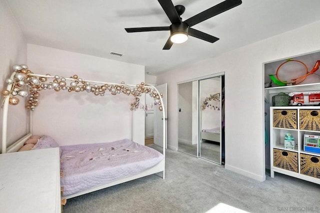 carpeted bedroom featuring a closet and ceiling fan