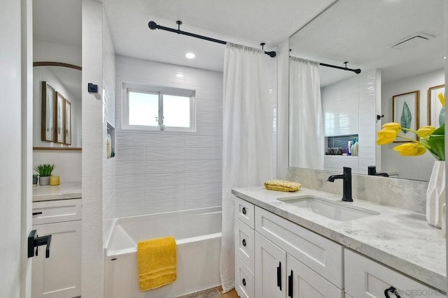 bathroom featuring shower / tub combo and vanity