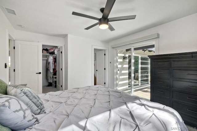 bedroom with a walk in closet, access to exterior, ceiling fan, and a closet