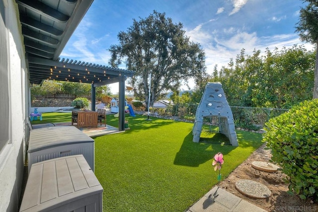 view of yard featuring a playground and a pergola