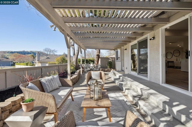 view of patio / terrace featuring an outdoor living space, a mountain view, and a pergola