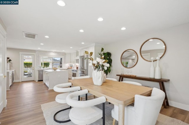 dining space with light wood-type flooring