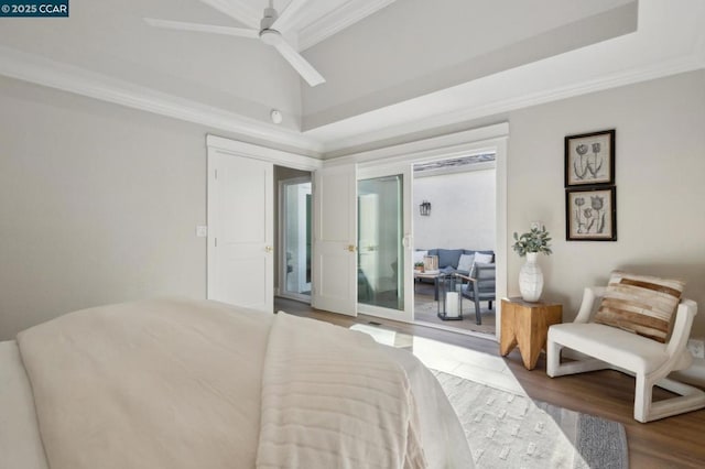 bedroom featuring crown molding, wood-type flooring, vaulted ceiling, access to outside, and ceiling fan