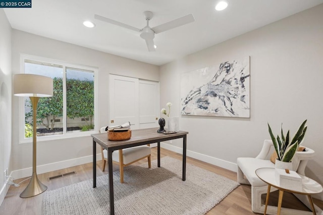 office featuring ceiling fan, a healthy amount of sunlight, and hardwood / wood-style floors