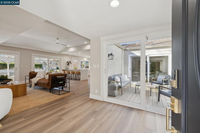 doorway featuring ceiling fan and light wood-type flooring