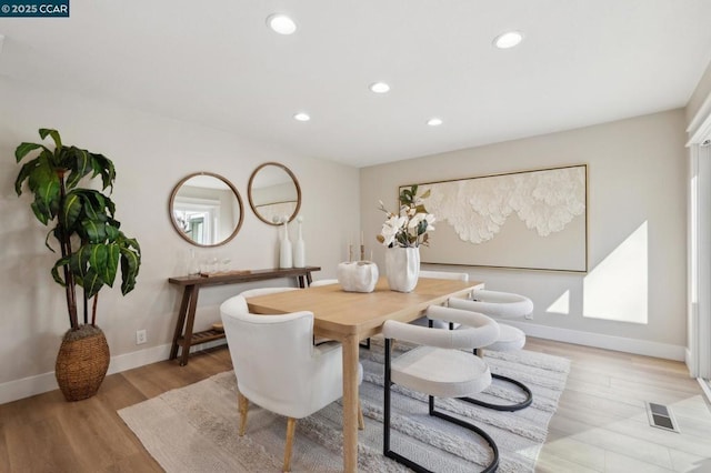 dining area with light hardwood / wood-style flooring