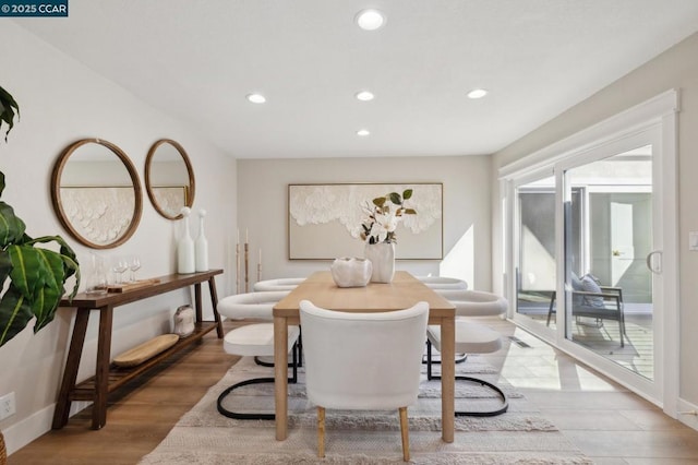 dining space with light hardwood / wood-style floors