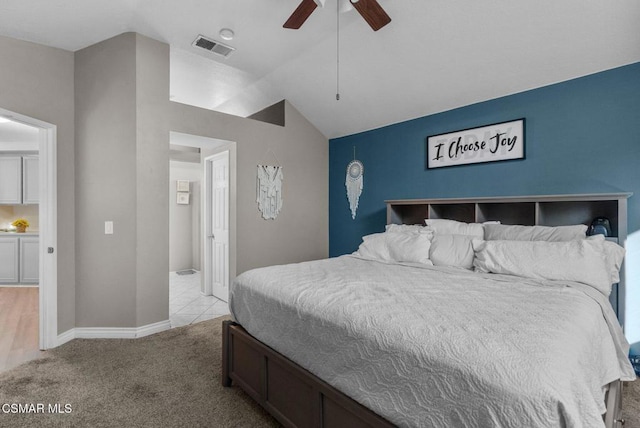 bedroom with ceiling fan, light colored carpet, and lofted ceiling