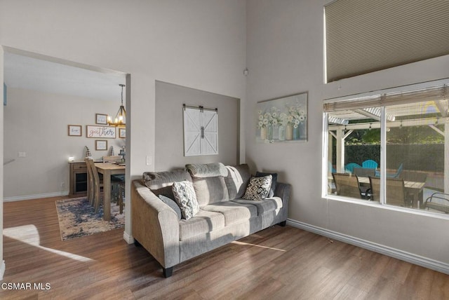 living room featuring dark hardwood / wood-style floors and a chandelier