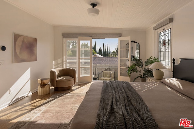 bedroom with crown molding, wooden ceiling, and hardwood / wood-style floors