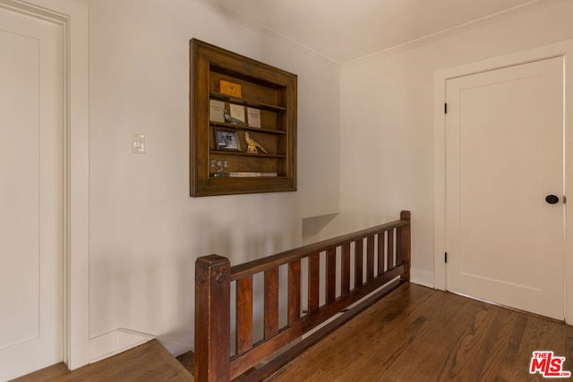 stairway with hardwood / wood-style floors and crown molding