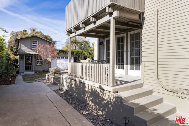 wooden deck with a garage and an outdoor structure