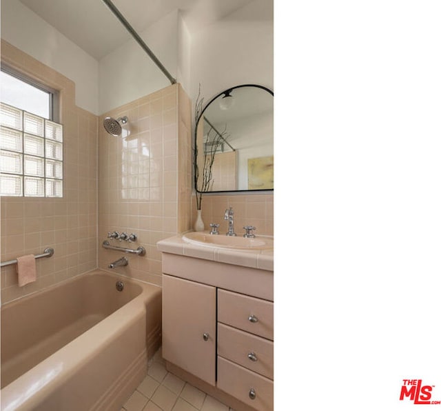 bathroom featuring tiled shower / bath combo, tasteful backsplash, tile patterned flooring, and vanity