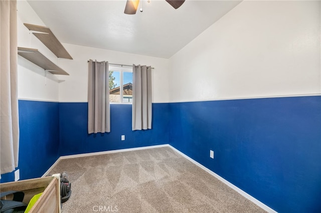 carpeted empty room featuring ceiling fan and lofted ceiling