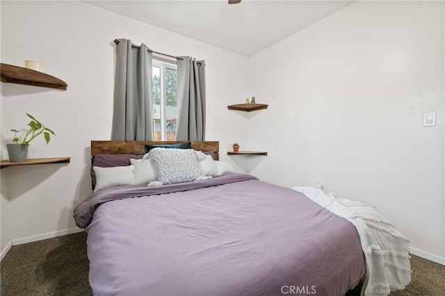 bedroom featuring vaulted ceiling and dark carpet